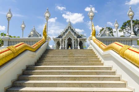 Thai Buddhist temple decorated with white ornaments with dragons and lanternsの写真素材