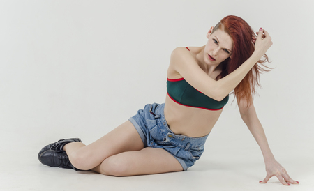 Beautiful girl undressing in jeans and bra beautiful lingerieの写真素材
