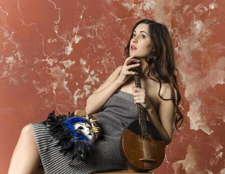 woman in retro dress with carnaval maskの写真素材