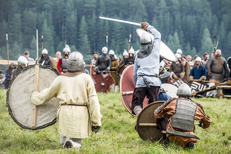 Russia, Kimry, July 28, 2018, reconstruction of the medieval battle. warriors in armor festival of ethnical culture on the Volgaのeditorial素材