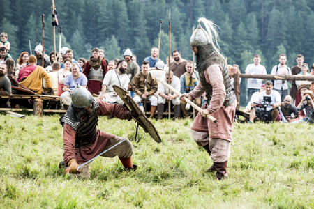 Russia, Kimry, July 28, 2018, reconstruction of the medieval battle. warriors in armor festival of ethnical culture on the Volgaのeditorial素材