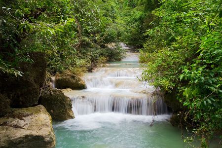 Stream flowing through tropical forest, Thailand.の写真素材