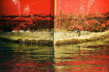 Bow of the boat and reflections on the water.の写真素材