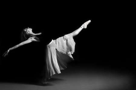 Beautiful young ballet dancer performing on stage.の写真素材