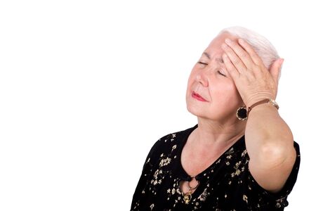 Old woman with migraine headache. Lots of copyspace and isolated on white background.の写真素材