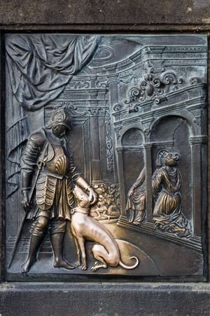 An old relief below the statue of St. John of Nepomuk on Charles Bridge in Prague, Czech Republic. According to legend good luck and a promise of return trip to Prague comes to those who touch it.の写真素材