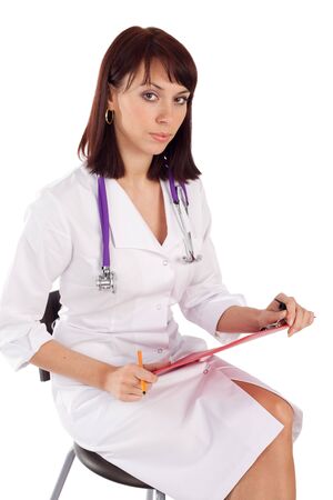 Young confident female doctor sitting, isolated on white background.の写真素材