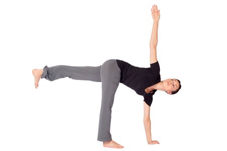 Young fit woman doing yoga exercise called Half Moon (Sanskrit name: Parivrtta Ardhachandrasana), isolated on white background.の写真素材