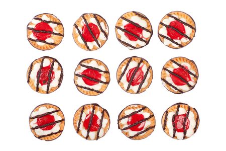 Dozen of delicious sweet biscuit cookies with jelly, icing and chocolate on top, isolated on white background.の写真素材