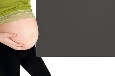 Pregnant woman with a blank gray board close-up isolated against white backgroundの写真素材