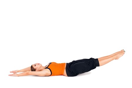 Woman doing first stage of yoga exercise called: Upward Extended Feet Pose, sanskrit name: Urdhva Prasarita Padasana, isolated on white backgroundの写真素材