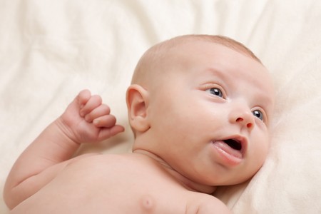 Beautiful six weeks old little baby girl looking to the right fascinated with something