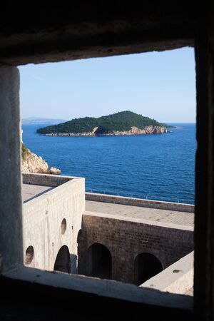 Framed view on Lukrum island on the Adriatic Sea from Fort Lovrijenac in Dubrovnik, Croatiaの写真素材