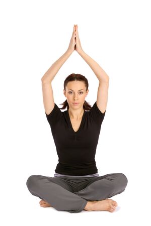 Pretty young woman practicing yoga sitting asana, isolated on white backgroundの写真素材