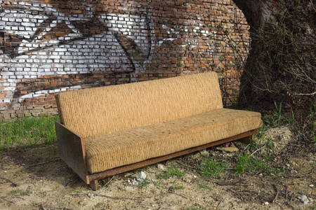 Aged abandoned folding sofa in the city suburbsの写真素材