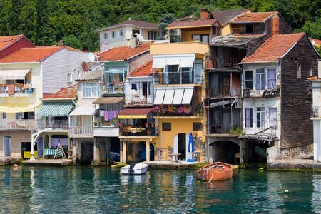 Picturesque residential houses in tranquil scenery of Anadolu Kavagi village waterfront in Turkey at...