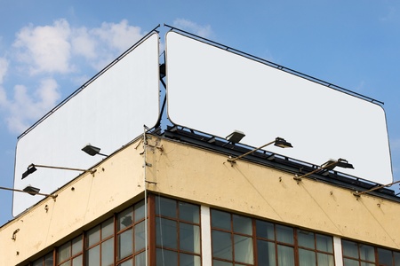 Two large blank billboards with copy space on a building roofの写真素材