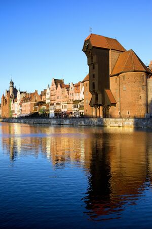 Early morning at scenic waterfront of the Old Town in Gdansk, Poland, on the right side of the image...