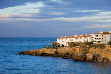 Morning at scenic coastline of the Mediterranean Sea with apartment houses on a rocky shore in Nerja town at the Costa del Sol, Andalusia region, Spainの写真素材