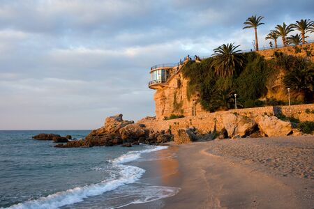 Sunrise on a beach at Balcon de Europa in Nerja, Costa del Sol, southern Spainの写真素材