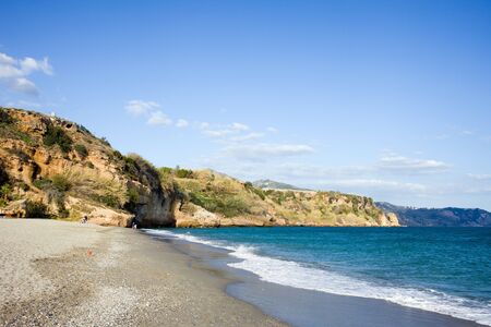 Tranquil coastline with an empty sandy beach by the Mediterranean Sea in resort town of Nerja, Costa del Sol, Malaga province, Spain.の写真素材