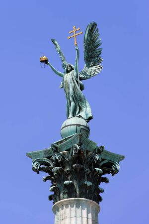 Archangel Gabriel statue holding Holy Crown of St. Stephen and Apostolic Cross, part of the Millennium Monument on the Heroes Square in Budapest, Hungary.の写真素材