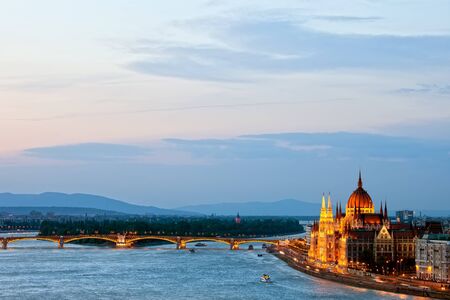 Budapest at dusk with Hungarian Parliament Building and Margaret Bridge on Danube river.の写真素材