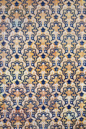 Old traditional design on a tiled wall of the Plaza de Espana corridor in Spain.