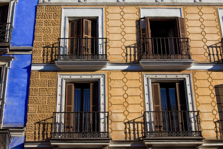 Old apartment building with balconies ornate facade in Madrid, Spain.のeditorial素材