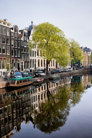 Houses along Singel canal historic waterfront, city of Amsterdam in spring, Holland.の写真素材