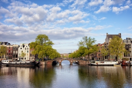 Dutch houses and bridge by the Amstel river in Amsterdam, Netherlands, North Holland province.の写真素材