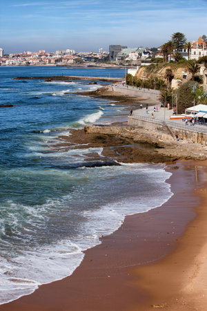 Beach and promenade along the Atlantic Ocean coast in resort towns of Estoril and Cascais in Portugal.のeditorial素材