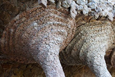 Architectural details in Park Guell by Antoni Gaudi in Barcelona, Catalonia, Spain, closeup on the top part of columns.のeditorial素材