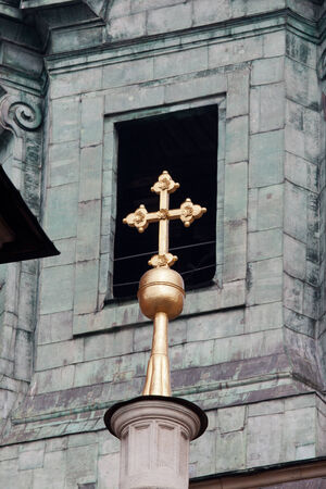 Golden cross against bell tower window of the Wawel Cathedral in Krakow, Poland.の写真素材