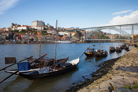 Rabelo traditional boats on Douro river, Dom Luis I Bridge and old city of Porto in Portugal.の写真素材
