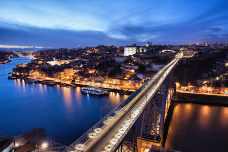 City of Porto at night in Portugal and Dom Luis I Bridge over Douro river.の写真素材