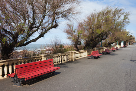 Promenade with benches along Atlantic Ocean coast in Foz district of Porto in Portugal.の写真素材