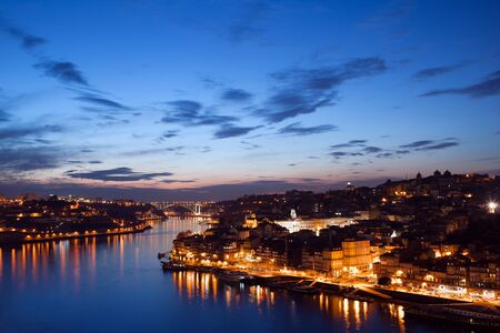 City of Porto in Portugal at twilight, tranquil waters of Douro river.の写真素材
