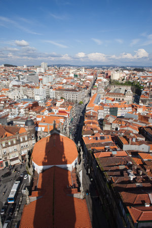 Cityscape of Porto in Portugal, view from above, shadow of Clerigos Church Tower on rooftop.のeditorial素材