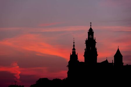 Krakow, Poland, Wawel Royal  Cathedral towers skyline silhouette at dusk.の写真素材