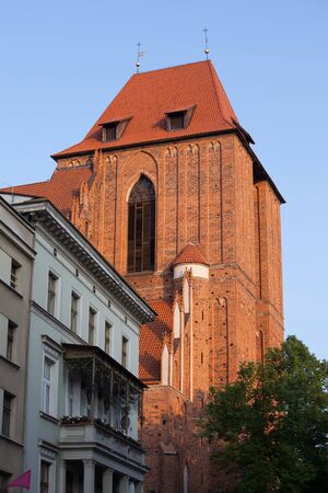 Torun, Poland, sunset at Gothic Cathedral Basilica of St. John the Baptist and St. John the...