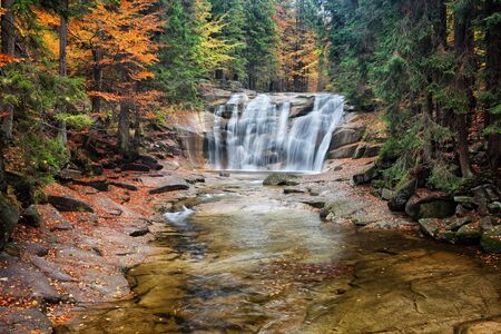 Mumlava waterfall in autumn forest of Giant Mountains (Krkonose, Karkonosze), Czech Republic.の写真素材