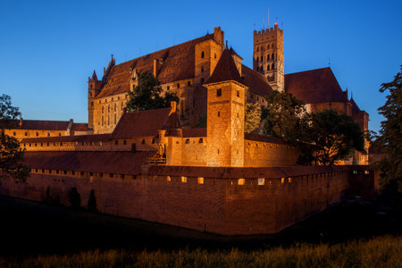 Malbork Castle by night in Poland, medieval fortress built by the Teutonic Knights, the largest brick castle in the world.のeditorial素材