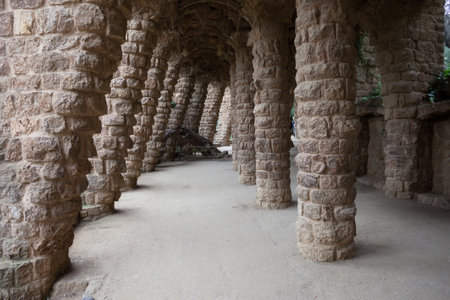 Spain, Barcelona, Park Guell, colonnaded passage with angled columns of Passeig de les Palmeres...