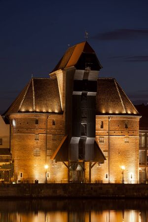 The Crane (Zuraw) illuminated at night in Gdansk, Poland, Europe, medieval landmark and symbol of...