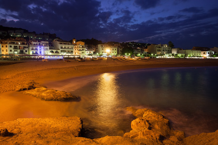 Spain, Costa Brava, Tossa de Mar town skyline and beach by night, coast of Mediterranean Seaの写真素材