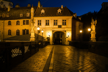 Entrance to Bratislava Old Town at night from Michalska Street, Slovakia, historic city center.の写真素材