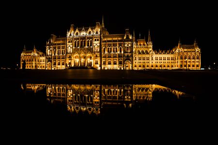 Hungary, Budapest, Hungarian Parliament Building lit up at night with mirror reflection in waterの写真素材
