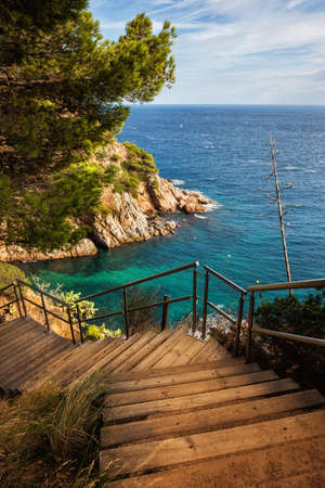 Wooden stairs to the sea on Costa Brava in Tossa de Mar, Catalonia, Spainの写真素材