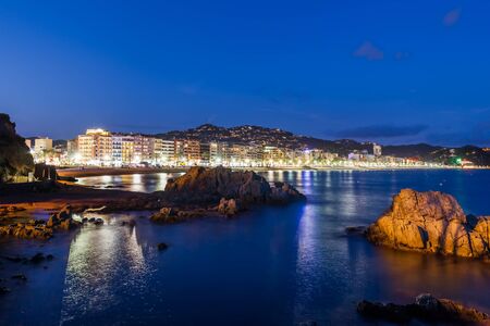 Lloret de Mar town at night on Costa Brava in Catalonia, Spain, coast of the Mediterranean Sea and lights of the resort skyline.の写真素材